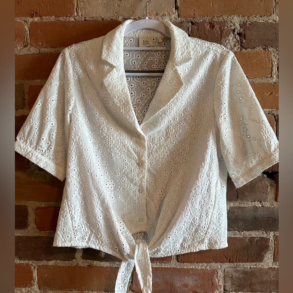 White eyelet shirt. Front of shirt has a lining. Was purchased in Paris.